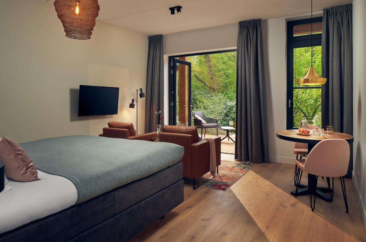 Een bed of bedden in een kamer bij Boutique Hotel Beekhuizen