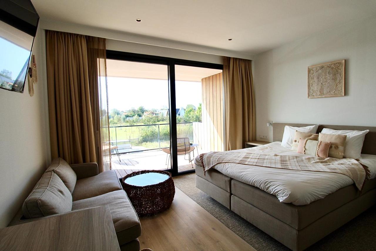 Een bed of bedden in een kamer bij Duinhotel Breezand