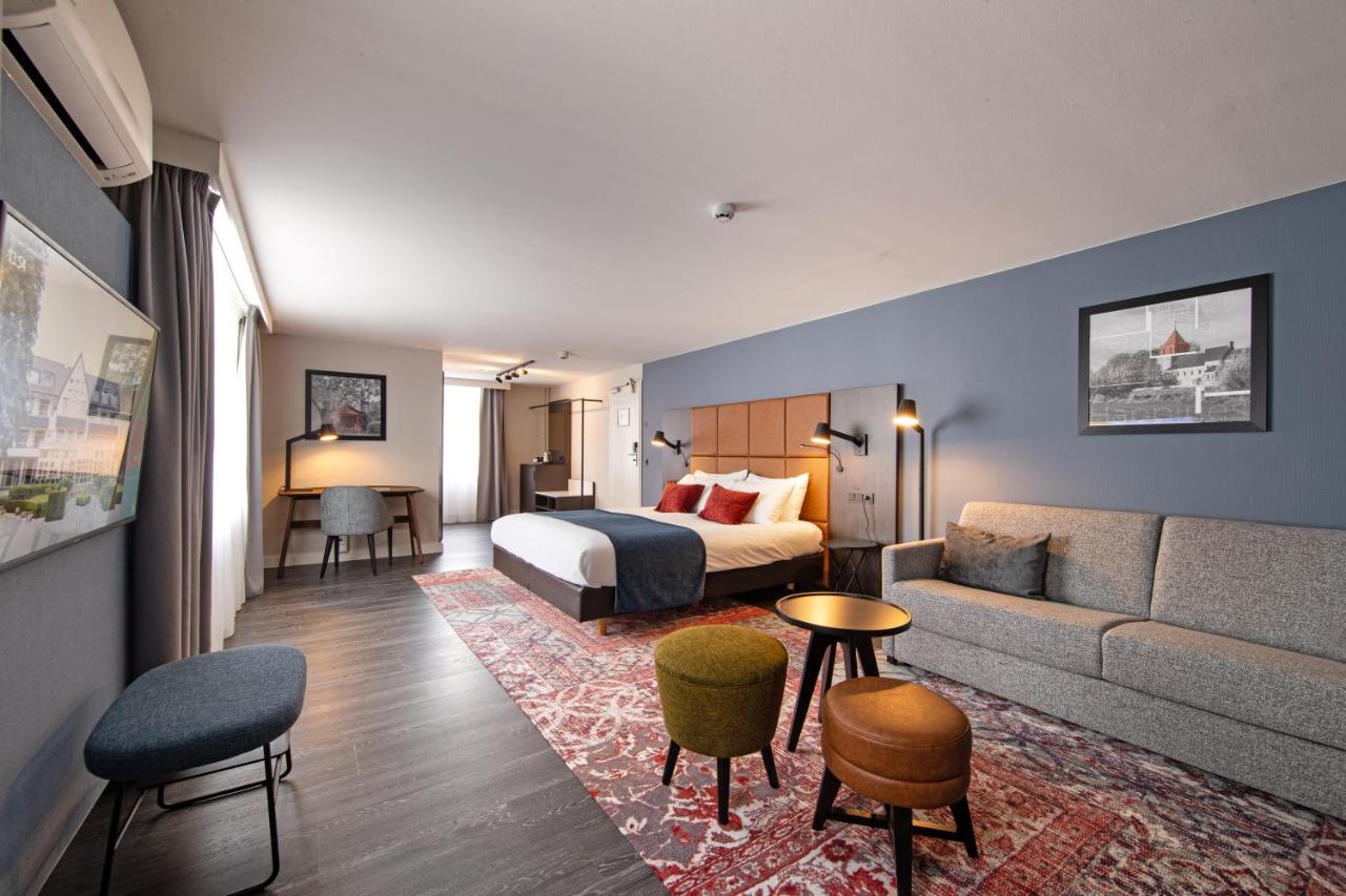 Een bed of bedden in een kamer bij Hotel De Bilderberg