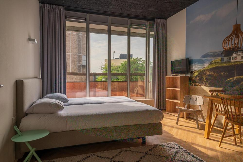 Een bed of bedden in een kamer bij Guesthouse Vertoef