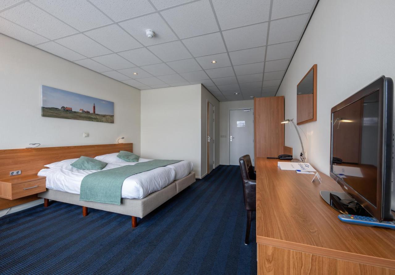 Een bed of bedden in een kamer bij Hotel de Branding