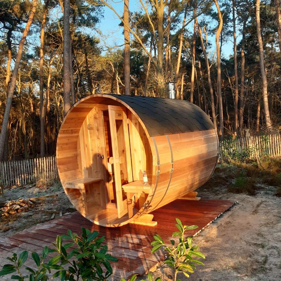 a wooden boat sitting on top of a wooden deck at Vakantiehuis met hottub en barrelsauna in Ommen