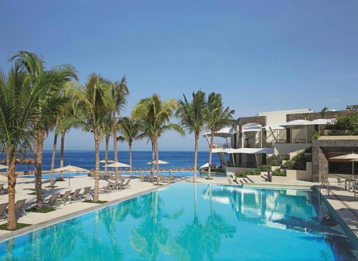 hotel with coconut trees and pool