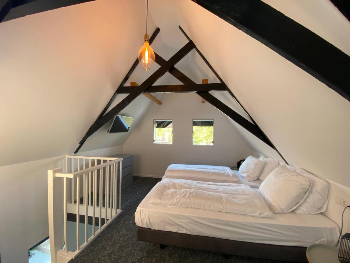 Een bed of bedden in een kamer bij Hotel Restaurant De Stadsherberg
