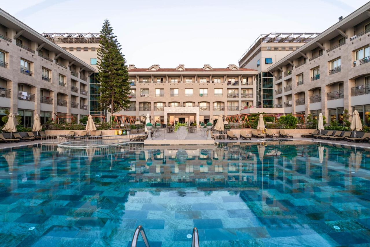 a large swimming pool in front of a hotel at Fame Residence Kemer & Spa in Kemer