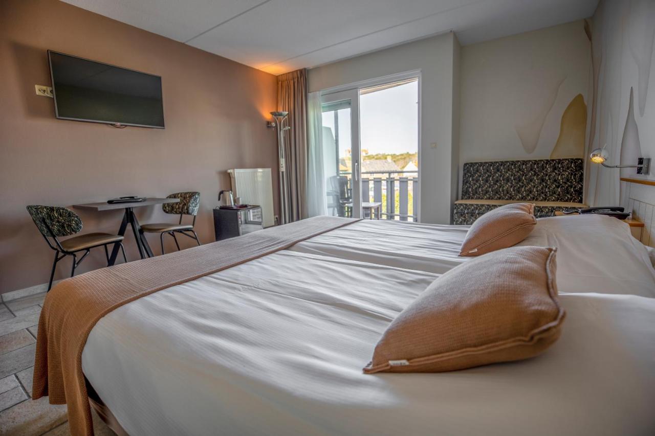 Een bed of bedden in een kamer bij Hotel Tesselhof