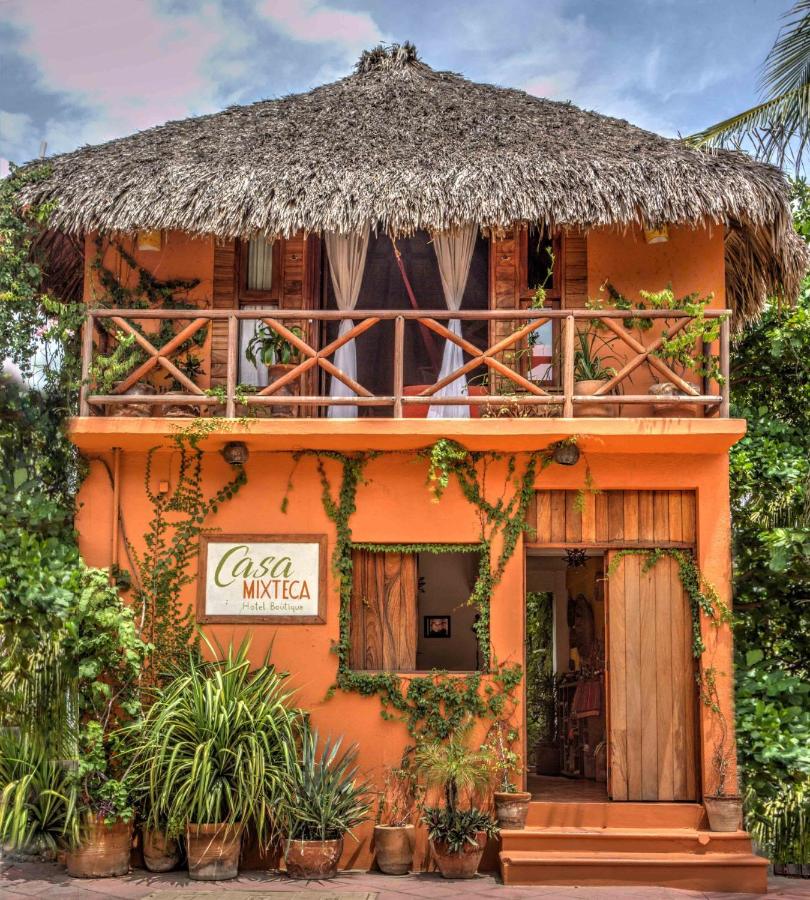 rust-colored villa in Hotel Casa Mixteca with green plants crawling on the walls