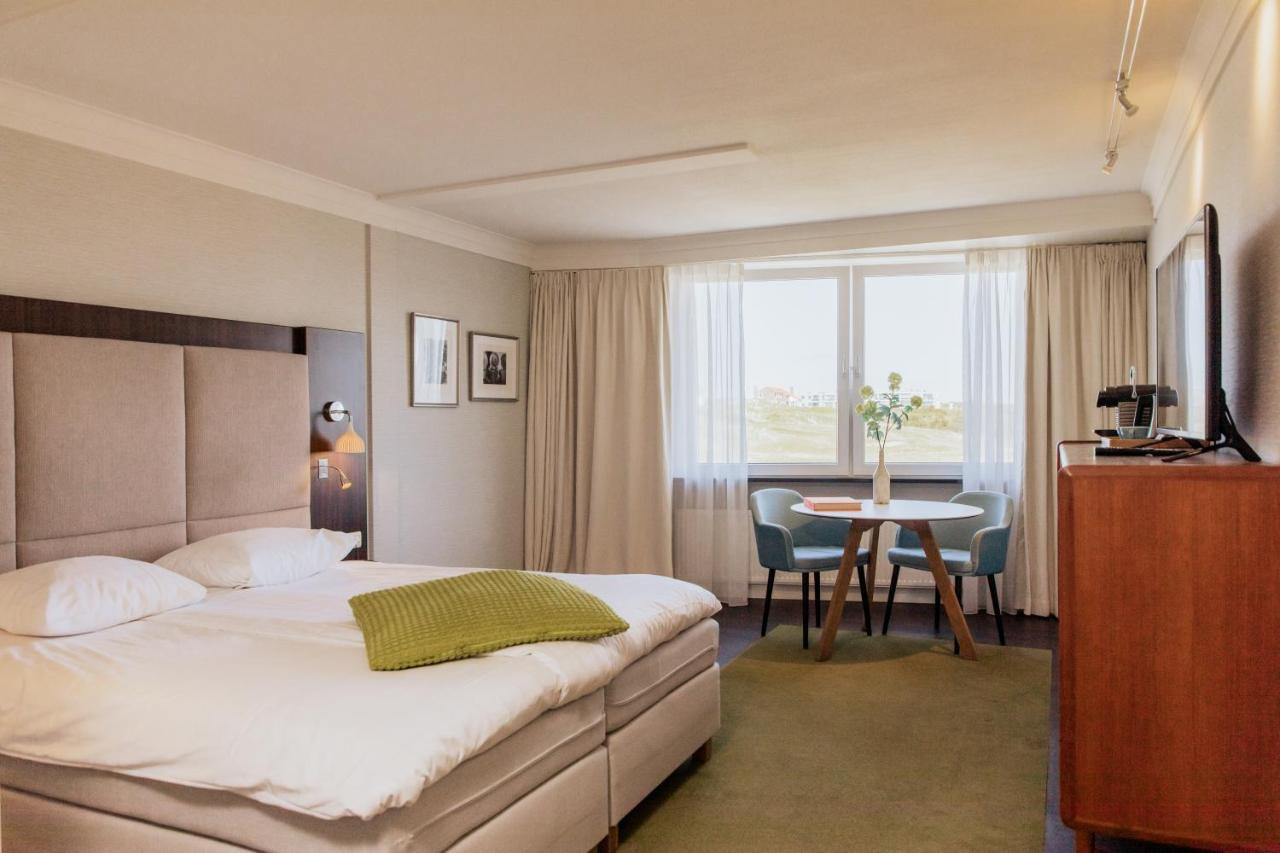 Een bed of bedden in een kamer bij Grand Hotel Opduin