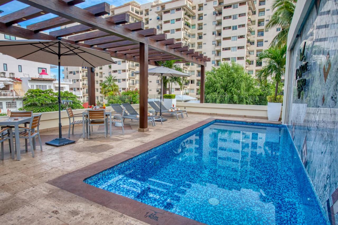hotel with pool, umbrellas, tables and chairs, lounges