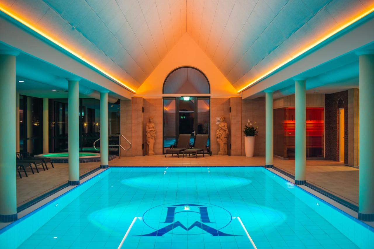 a swimming pool in the middle of a house at Havezate Marveld in Groenlo