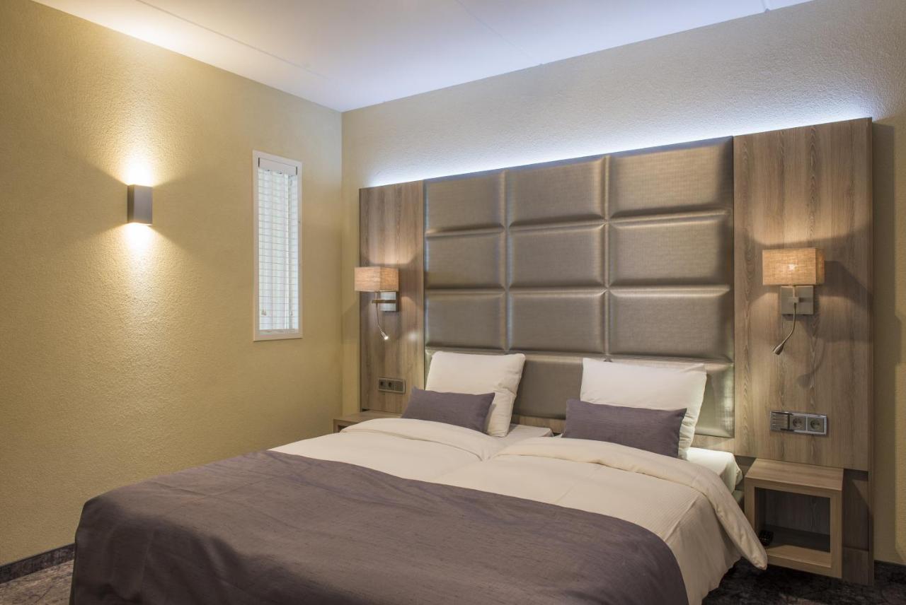 a bedroom with a large bed with two pillows at Havezate Marveld in Groenlo