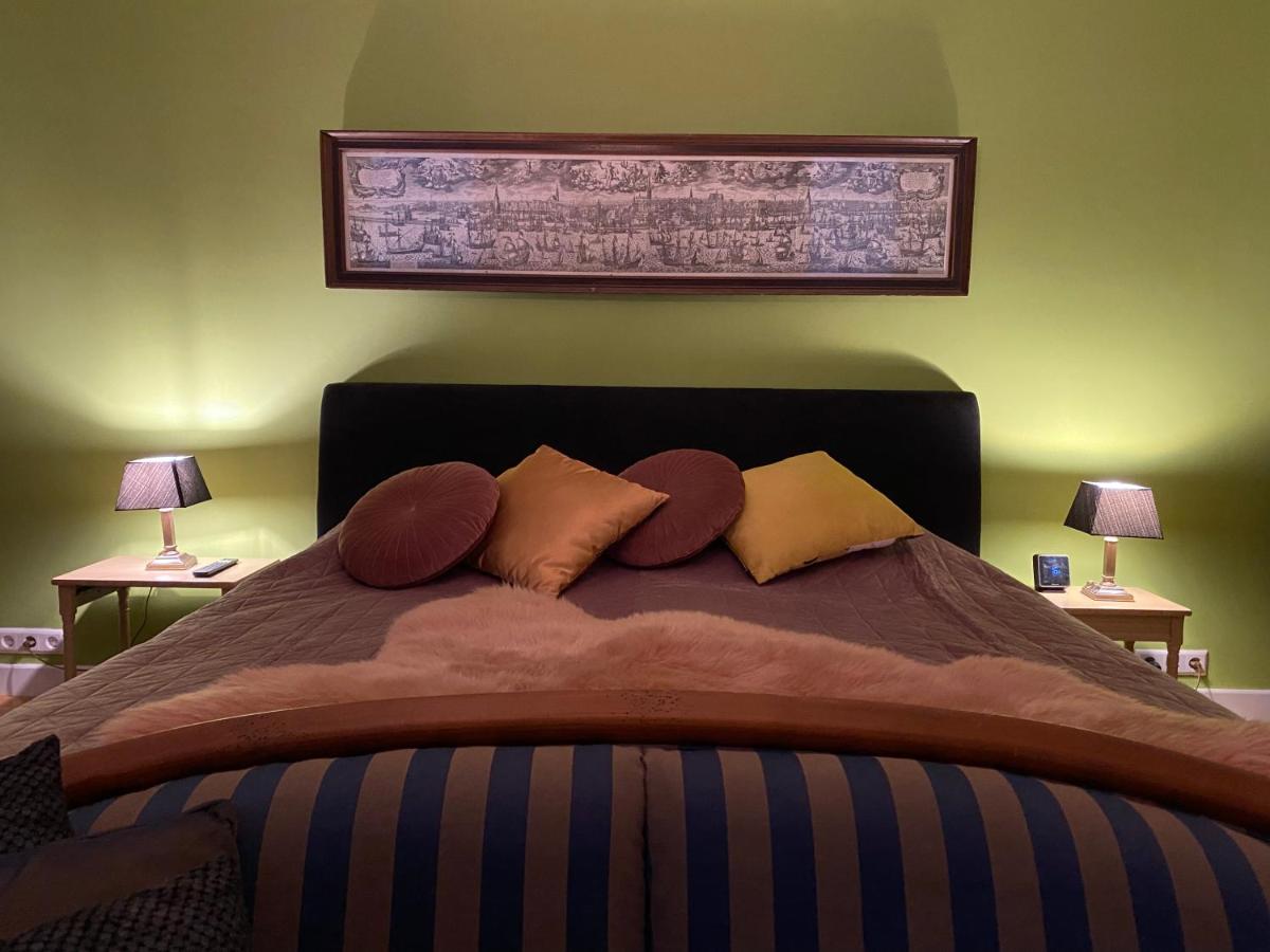 a bedroom with a large bed with pillows on it at King Suite Centre Alkmaar in Alkmaar