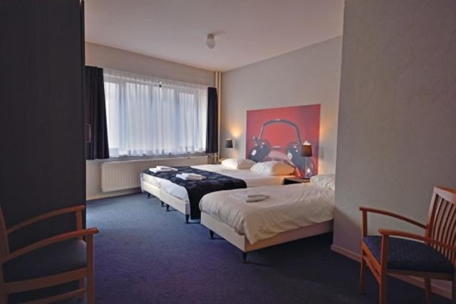Een bed of bedden in een kamer bij Royal