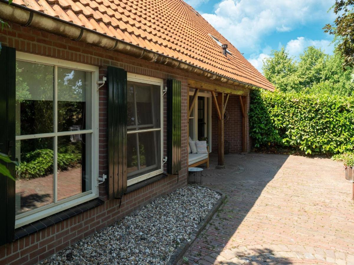 a house with sliding glass doors and a patio at House with a large garden in Achterhoek in Eibergen