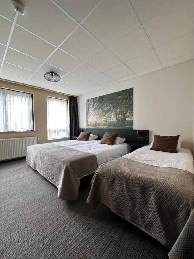 Een bed of bedden in een kamer bij Hotel Restaurant Talens Coevorden