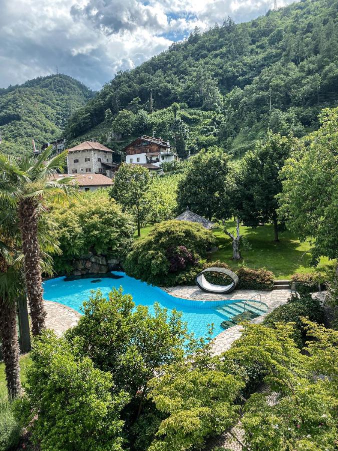 a greenery and luxury hotel pool in Italy