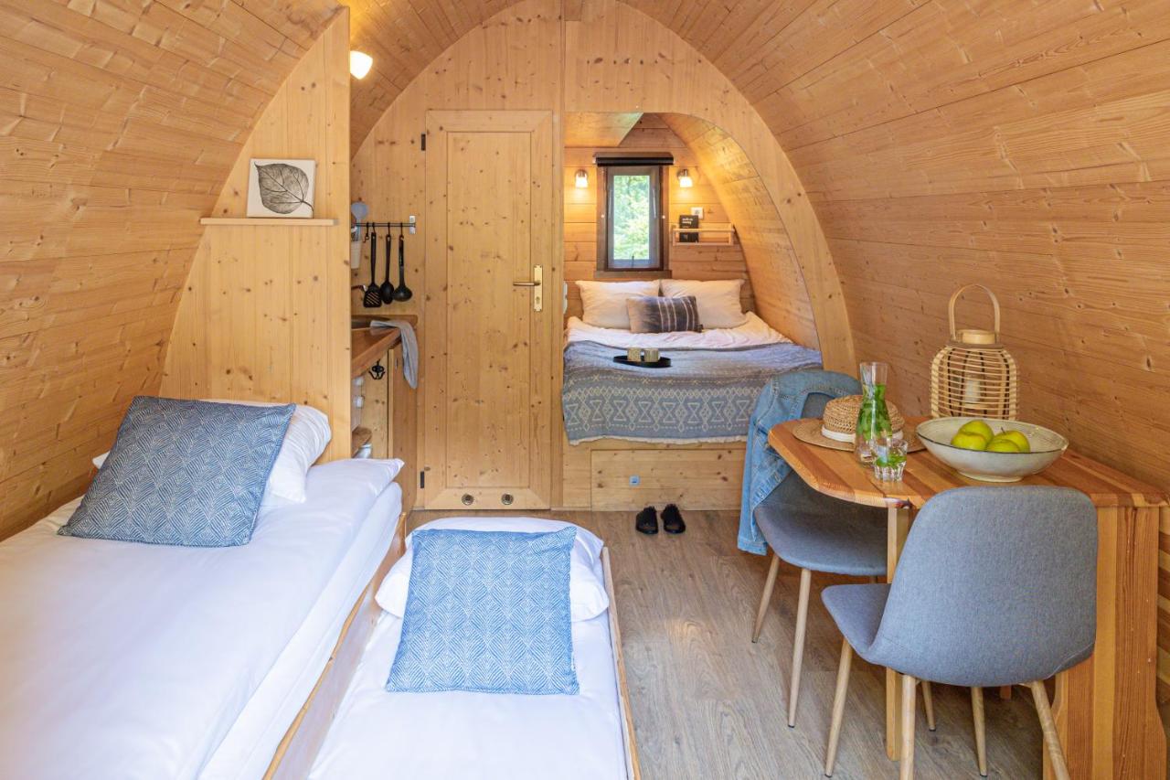 a small room with a bed and a table and a bedroom at Buitenplaats Beekhuizen in Velp