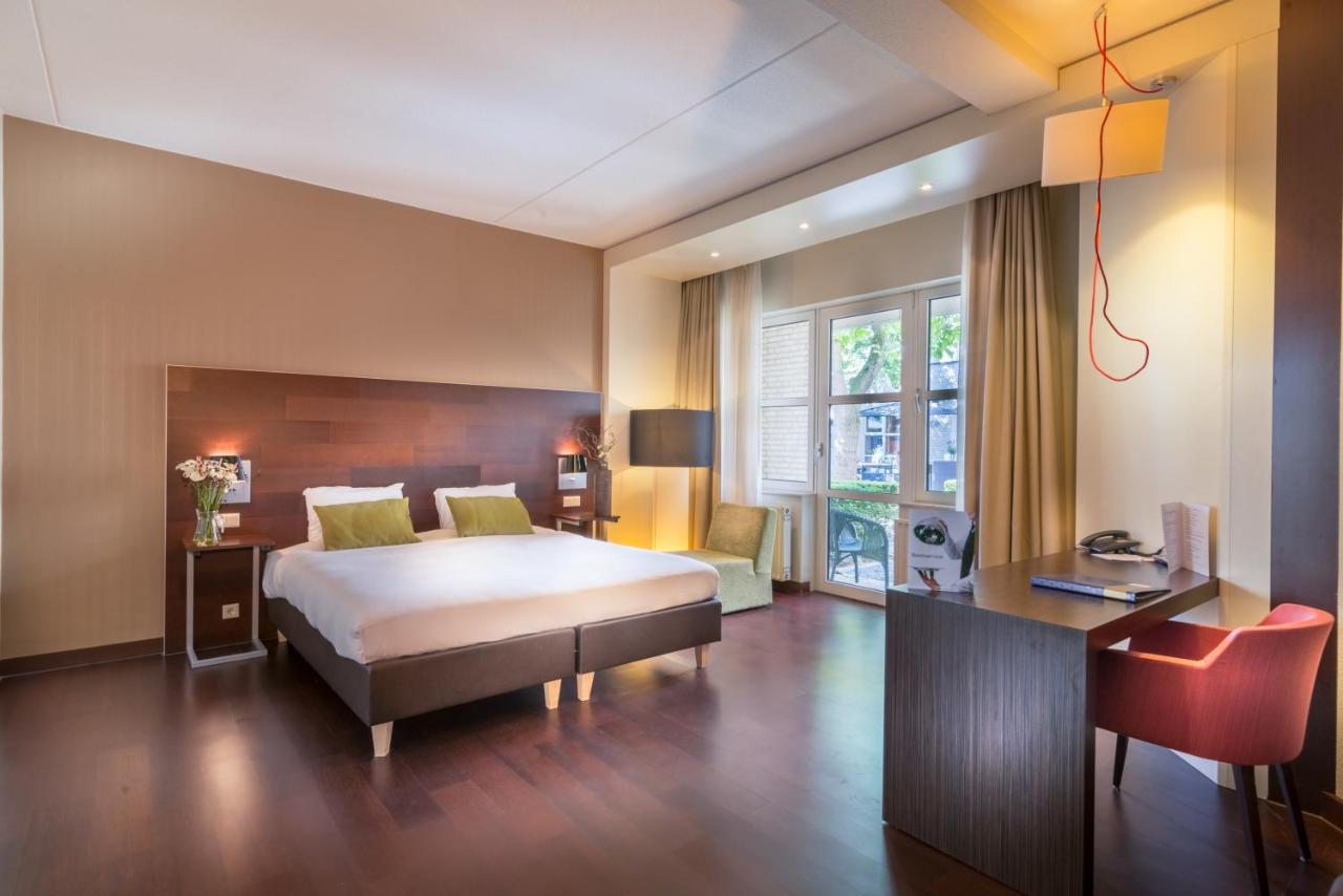 Een bed of bedden in een kamer bij Golden Tulip Ampt van Nijkerk
