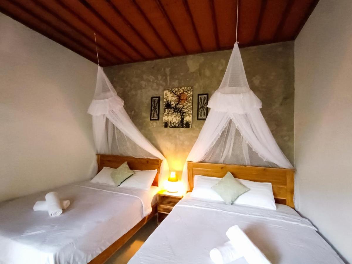 Een bed of bedden in een kamer bij Artomoro Bali