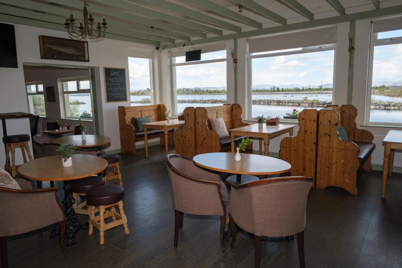 Cozy restaurant interior with wooden furniture and water view.