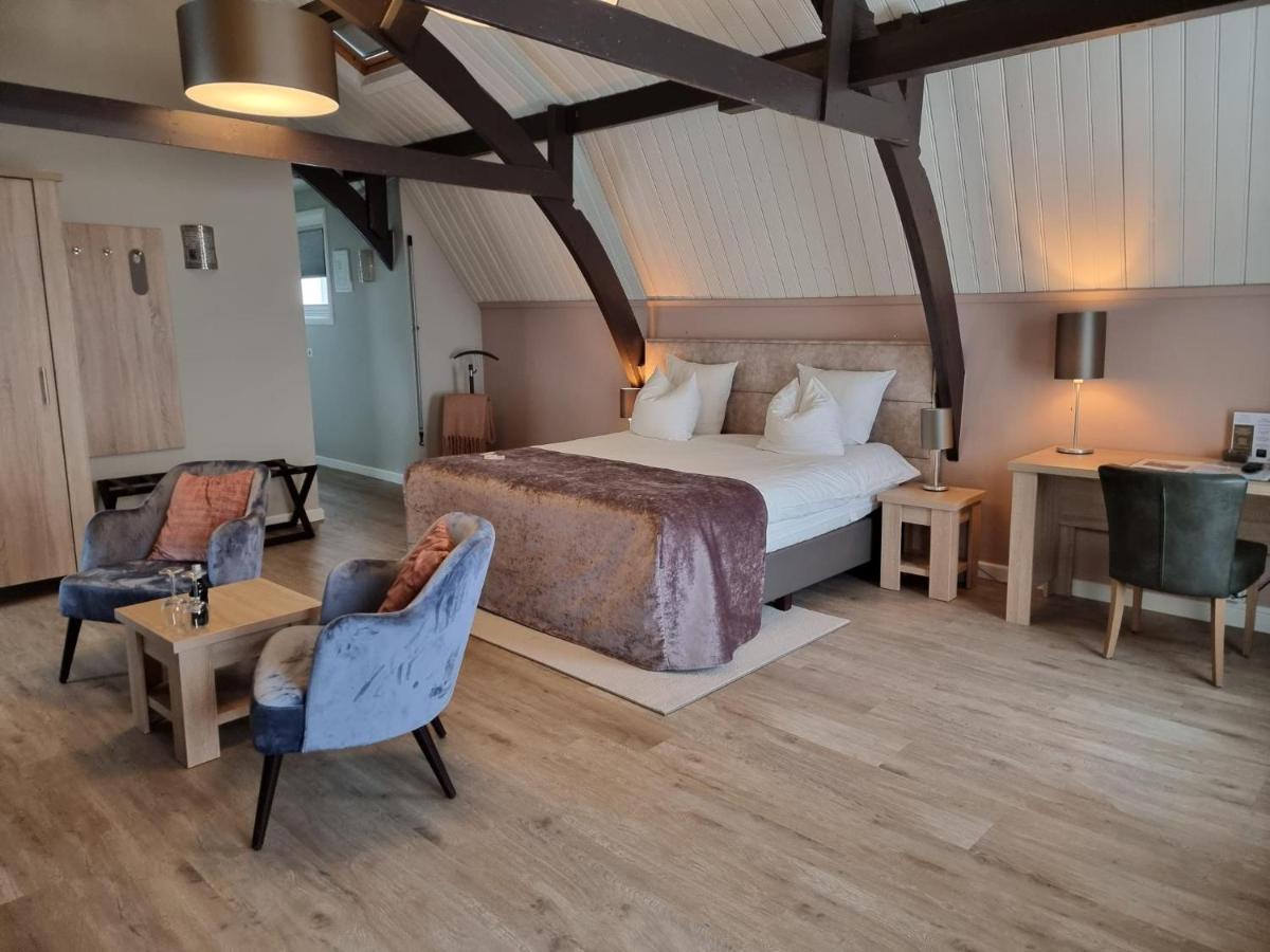 Een bed of bedden in een kamer bij Herberg Welgelegen