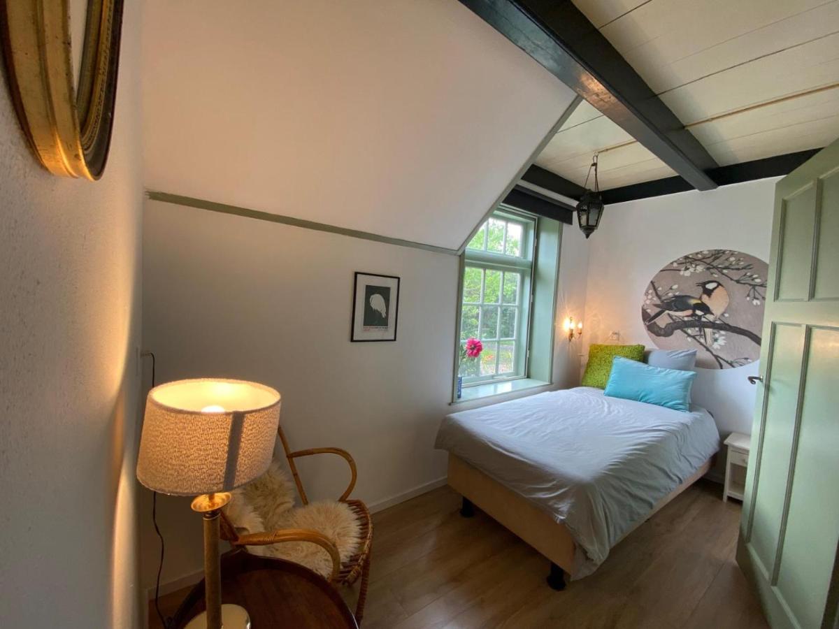 Een bed of bedden in een kamer bij Het Hooge Huis