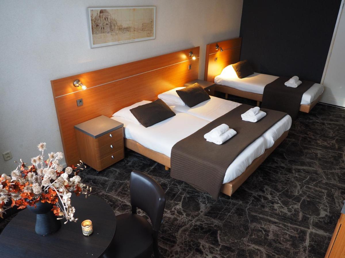 Een bed of bedden in een kamer bij Hotel 't Anker