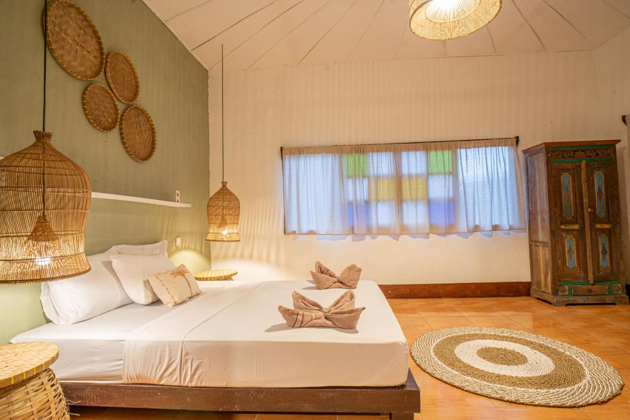 Een bed of bedden in een kamer bij Jungalow