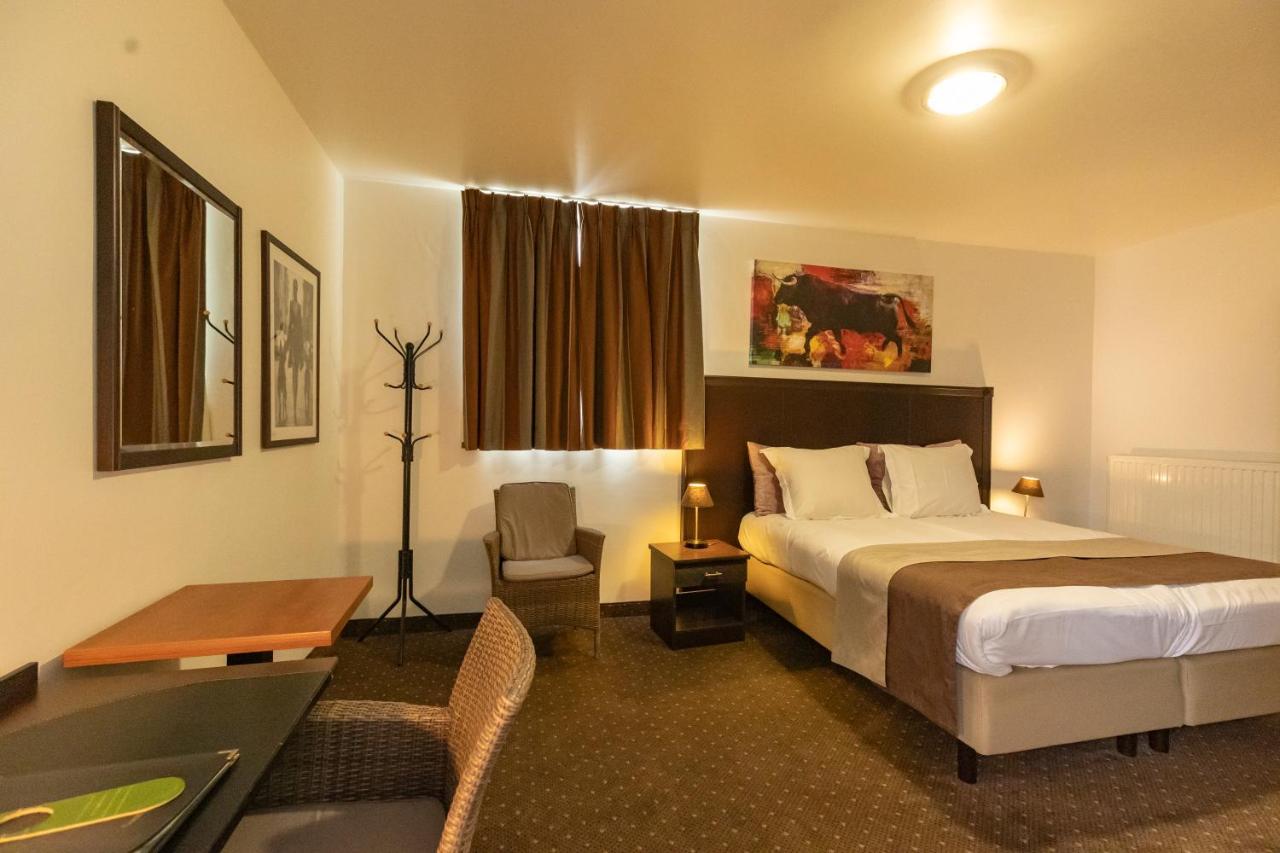 Een bed of bedden in een kamer bij Hotel Malon
