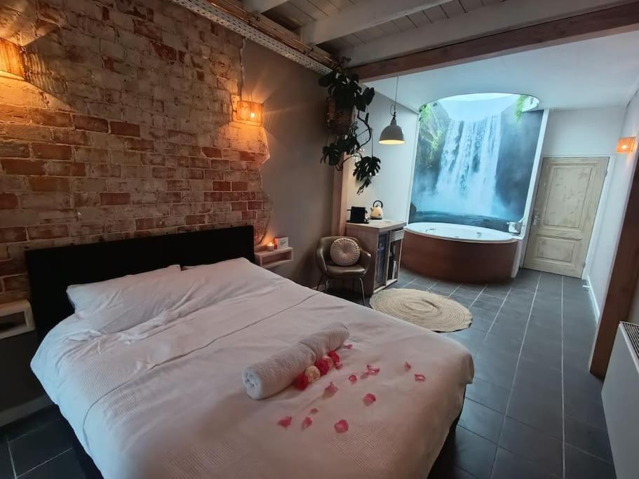 Een bed of bedden in een kamer bij Waterval Wellness-suite met Sauna!
