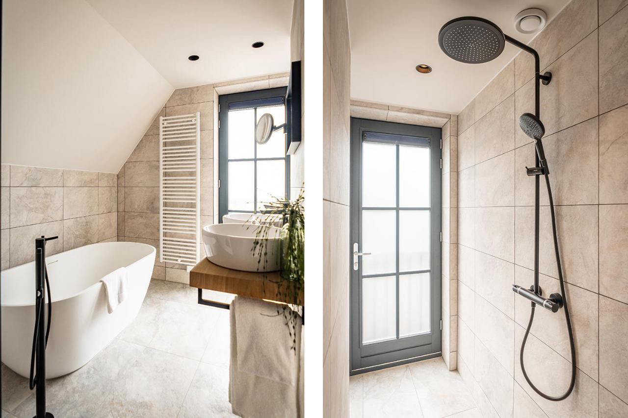 a bathroom with a bath tub and a shower at Prins Hendrik Texel in Oost