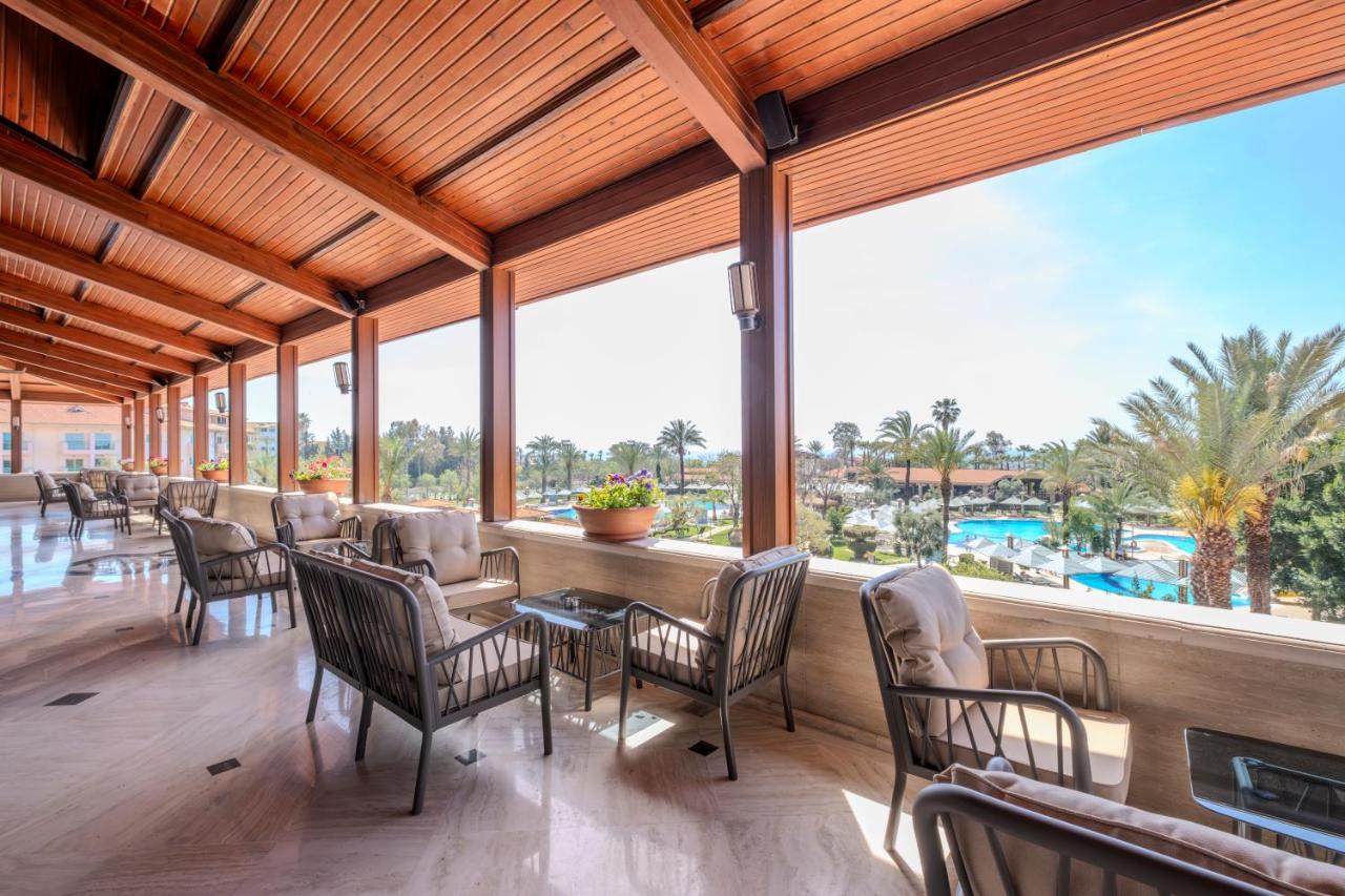 a dining room with chairs and a table and windows at Belconti Resort Hotel in Belek