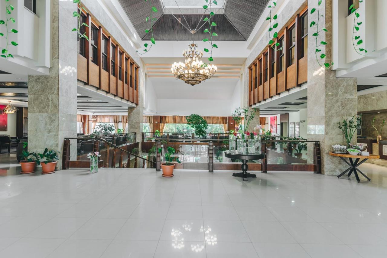 a large lobby with potted plants and a chandelier at Sural Resort Hotel in Side