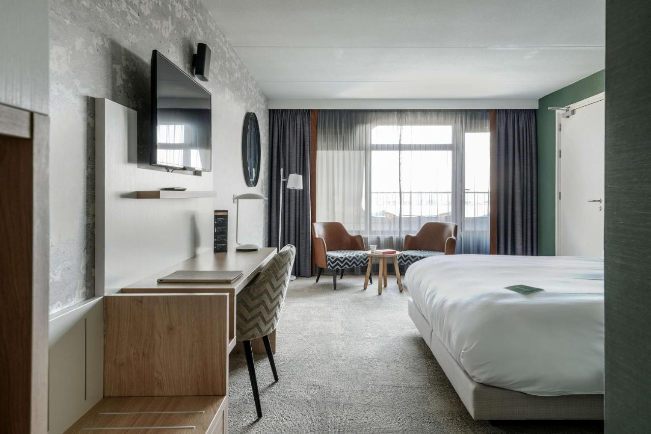 Een bed of bedden in een kamer bij Paal 8 Hotel aan Zee
