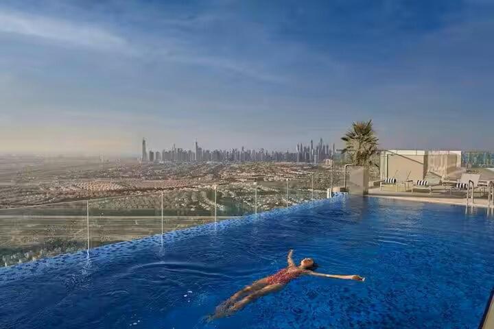 Vogue Vacation Homes, JVT Novotel near Springs Souk Mall, One Bedroom apartment with Balcony and Vibrant Community View, Access to all Amenities