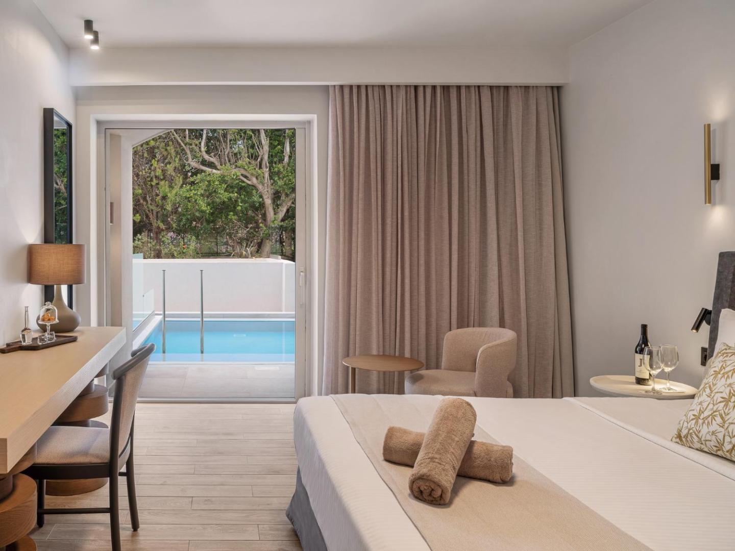 Moderns viesnīcas numurs ar skatu uz privātu baseinu un dārzu.