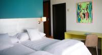 a hotel room with two beds and a desk at Hotel Ritual Torremolinos- Adults Only in Torremolinos