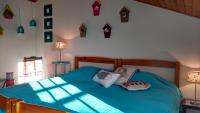 a bedroom with a blue bed with pillows on it at L&#39;Ondine in Pornic