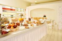 a breakfast buffet with a lot of food on a counter at Ionion Star Hotel in Lefkada Town