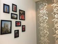 a wall with pictures and photographs on a wall at British Country Inn B&amp;B in Luodong