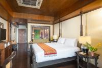 a bedroom with a large white bed and a television at Panviman Resort Koh Phangan - SHA Extra Plus in Thong Nai Pan Noi