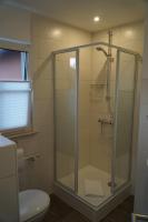 a bathroom with a glass shower with a toilet at Mansion in Bad Arolsen