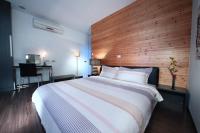a bedroom with a large bed with a wooden headboard at The Designer&#39;s House in Wujie