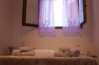 A bed or beds in a room at Dimora Rosso Piceno