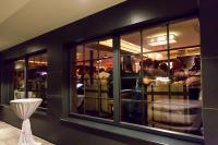 una ventana de restaurante con gente comiendo en un restaurante en Hotel Victoria - adults only, en Gerlos