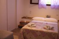 A bed or beds in a room at Dimora Rosso Piceno