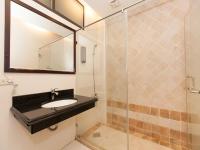 a bathroom with a sink and a glass shower at Kimoge Homestay in Hualien City