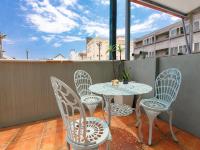 a balcony with a table and chairs on a balcony at Kimoge Homestay in Hualien City