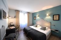 a hotel room with a bed and a window at The Originals Boutique, Hôtel du Parc, Cavaillon (Inter-Hotel) in Cavaillon