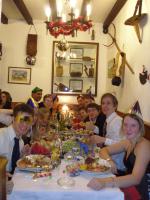 a group of people sitting around a table with food at Hotel des Alpes in Brides-les-Bains